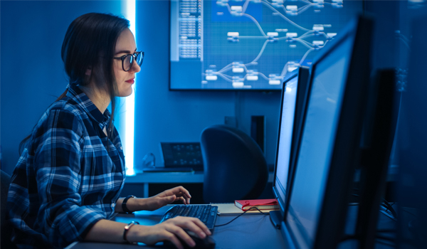 Female IT Engineer / Programmer Working on Desktop Computer. Software Development / Coding/ Web Design / Database Architecture.