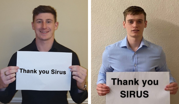 Sirus scholarship students holding thank you signs