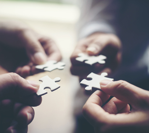 Hands holding jigsaw pieces