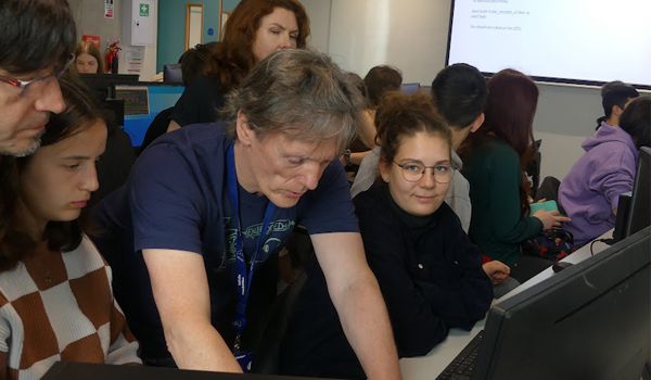 A lecturer demonstrating to a group of students