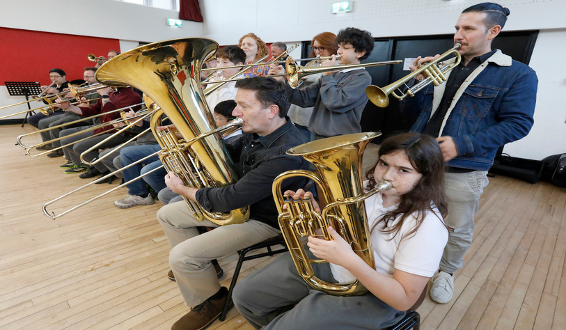 Students play brass instruments