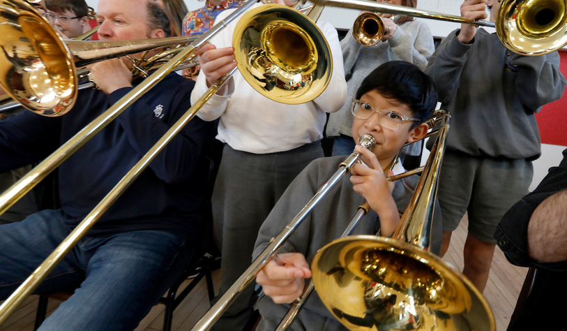 Students play brass instruments