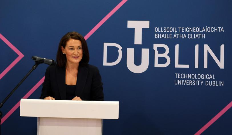 Deputy Erin McGreehan, Chair of the Oireachtas Committee on Further and Higher Education speaking at an event in front of a TU Dublin banner