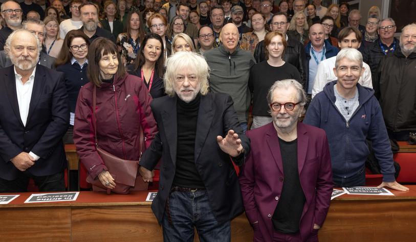 A photo of Pete Briquette and Sir Bob Geldof with staff and students in Bolton Street