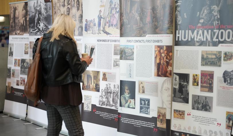 A person looking at an exhibition of pull up stands