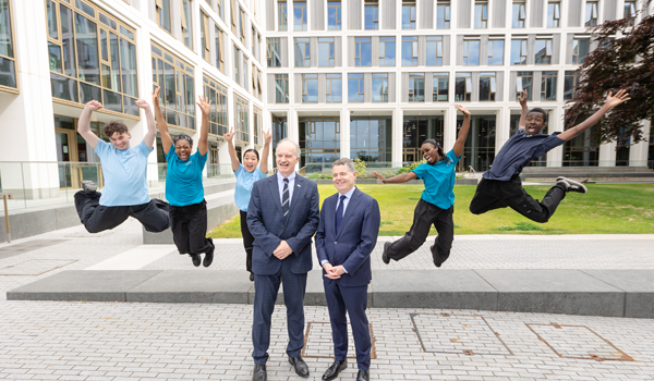 A group of students jump for joy at a launch event for Grangegorman