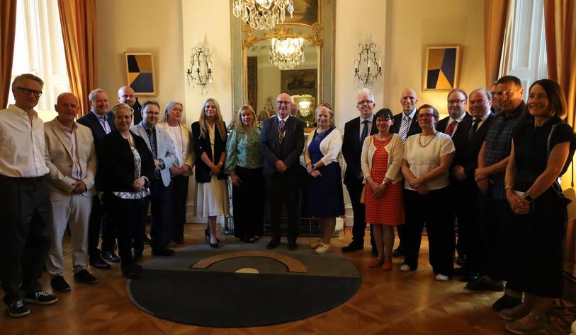 A group of people pose for a photo at a ceremony in the French Embassy to honor Dr Eamon Maher