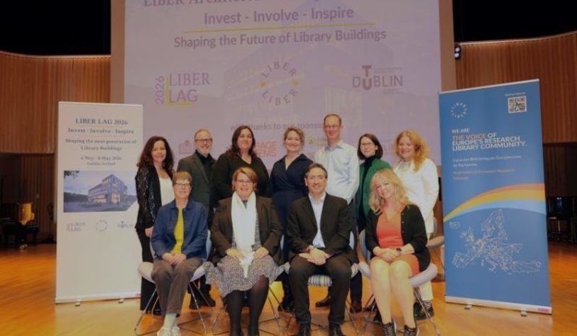 A group of people pose in front of a large banner that says LIBER LAG Seminar,