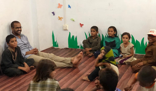 A photo of students attending a school in Pakistan which Moazzam built