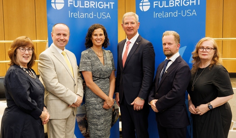 A group of people hold a sign