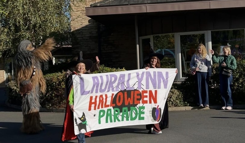 Two participants hold a colourful banner reading