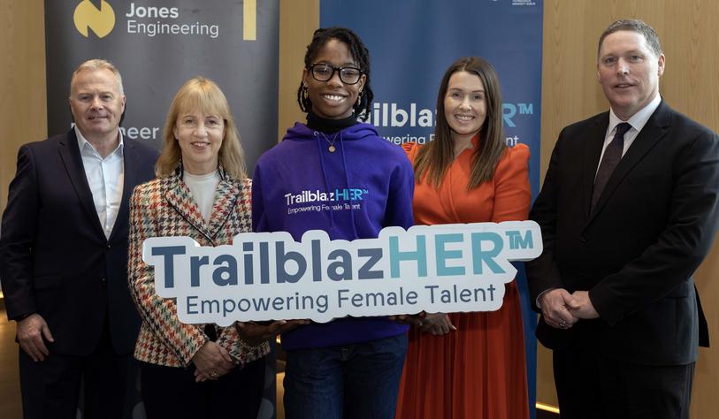 Image for Women holds a phone in her hand and looks out to her left.