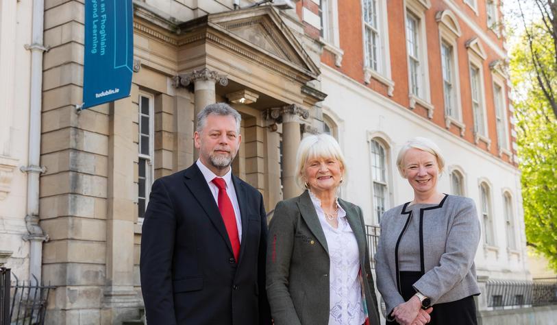 A group of people in front of a neo-classical building