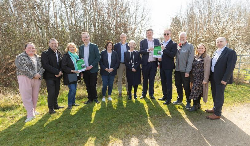 A group of people pose in a garden