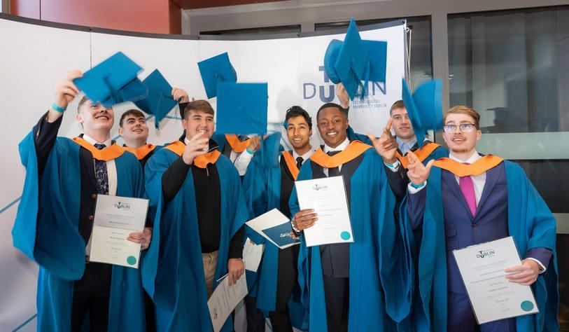 Students throw their Mortar Boards in the air