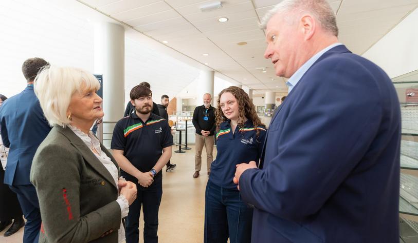 A group of people chat in a cafeteria