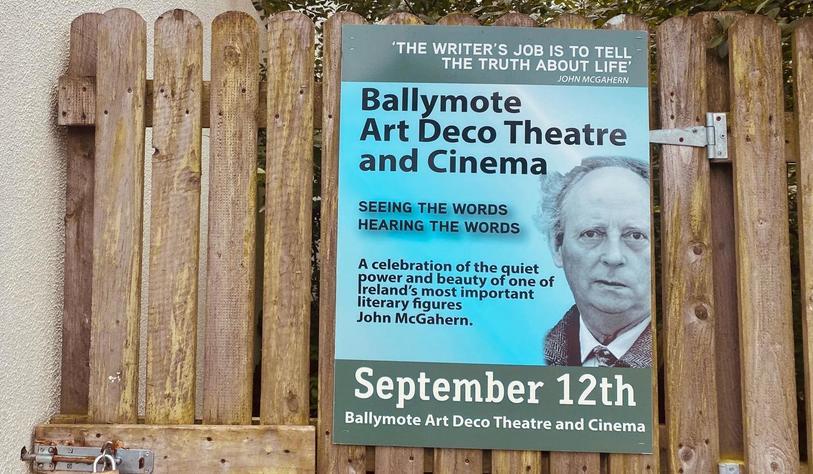 Poster attached to a wooden fence advertising “Ballymote Art Deco Theatre and Cinema: Seeing the Words, Hearing the Words,” a celebration of Irish writer John McGahern. The event is dated September 12th and features a portrait of McGahern.