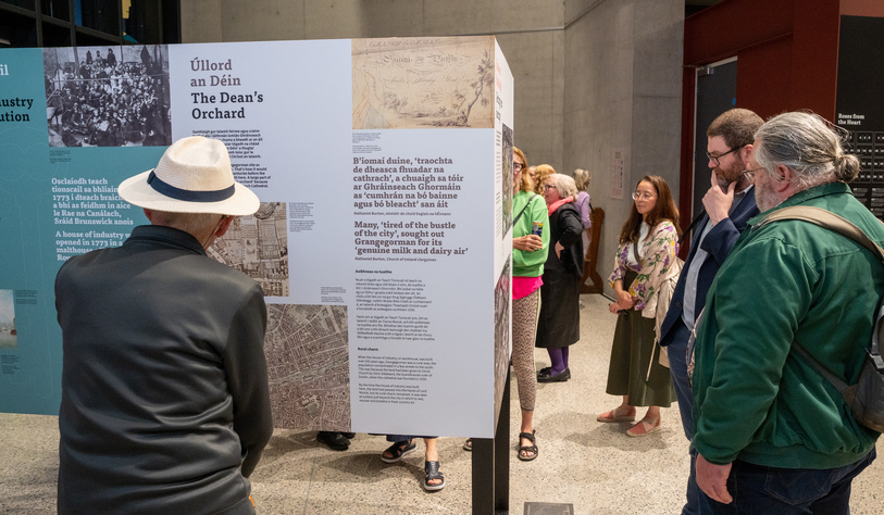 People viewing poster boards at an exhibition