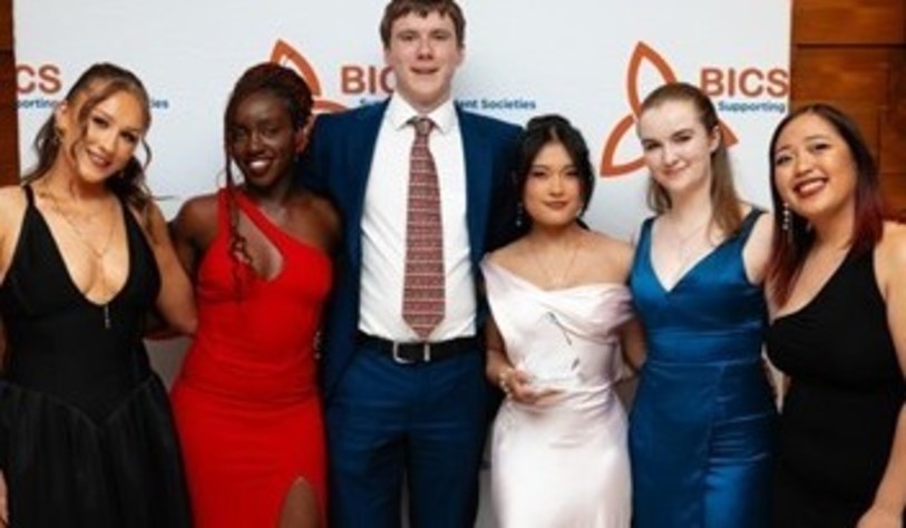 A group of people smiling and celebrating at an award show