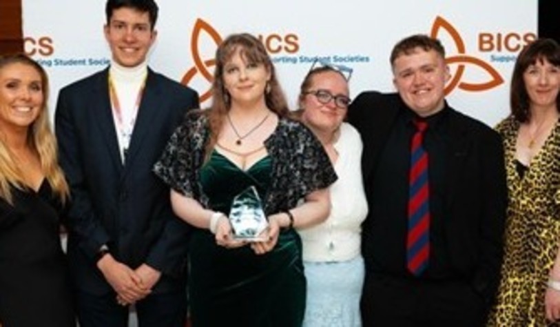 A group of people smiling and celebrating at an award show