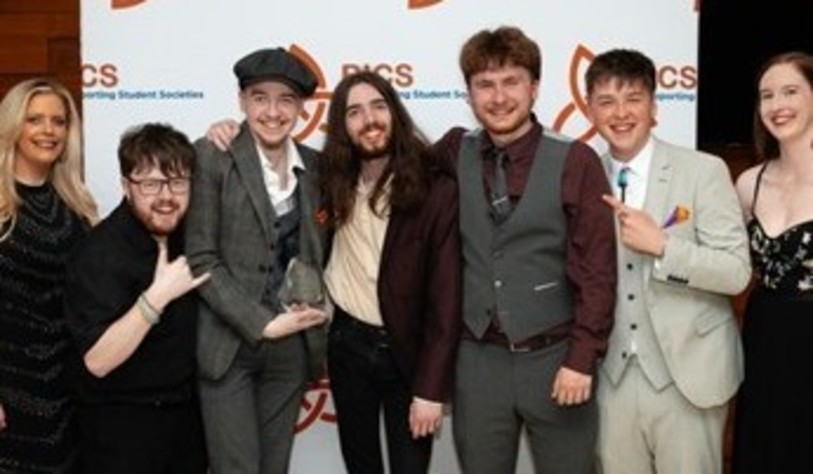 A group of people smiling and celebrating at an award show