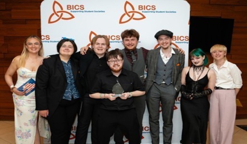 A group of people smiling and celebrating at an award show