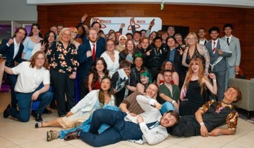 A group of people smiling and celebrating at an award show