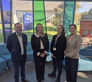 Four people standing together at TU Dublin’s Blanchardstown Campus, with TU Dublin and Brightspace signage visible in the background.