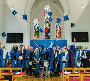 A group pose for a photo in front of  TU Dublin banner