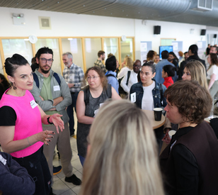 A group of people listen to a speaker at an event