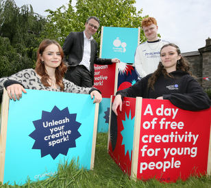 A photo of three young people with Minister Patrick Donavan at the launch of Cruinniú na nÓg 2026 in Grangegorman