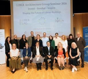 A group of people pose in front of a large banner that says LIBER LAG Seminar,