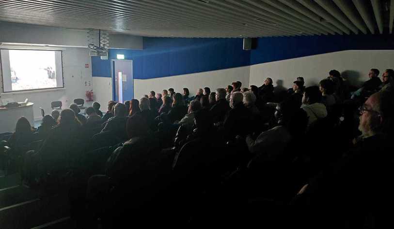 An audience watches a film