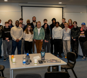 A group of students pose for a photo at an event