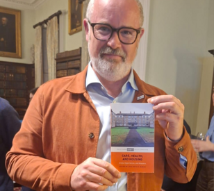 A photo of Joseph Little, a TU Dublin researcher, holding a book he contributed to
