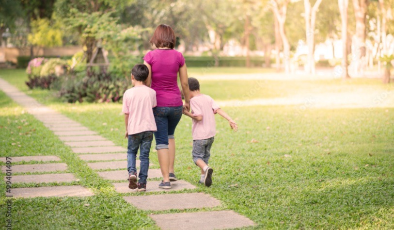 Mother walking with her children in park
