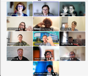 A screenshot of an online meeting, showing 13 people's faces, all smiling and some of them waving.