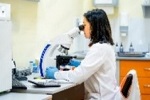A student using a microscope in a laboratory