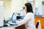 A student using a microscope in a laboratory