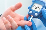 Medical professional checking blood sugar level with a glucometer