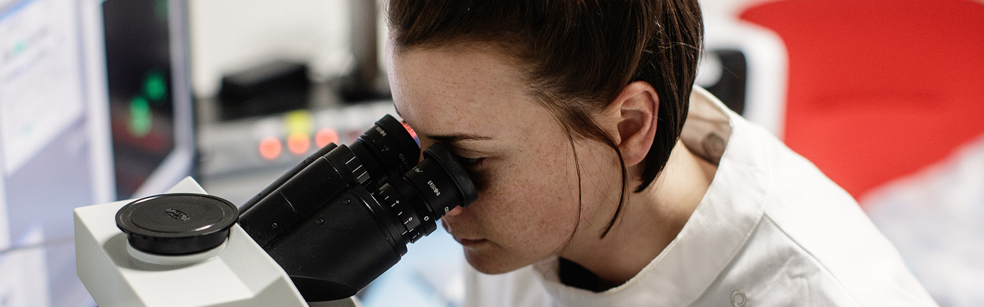 Student looking through a microscope