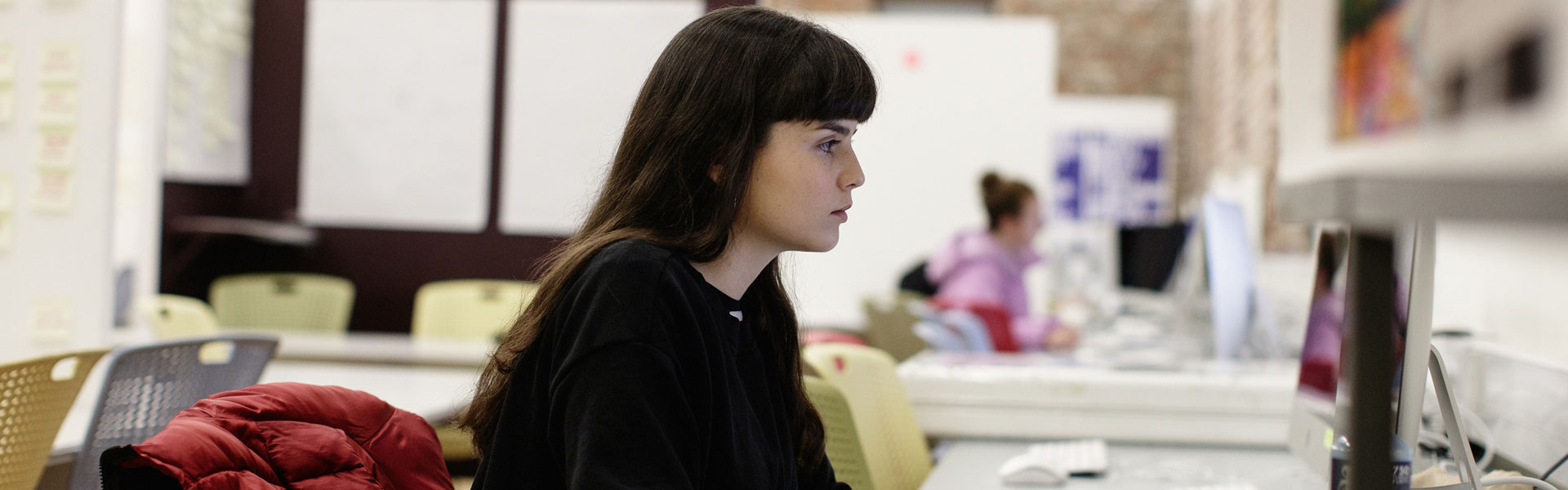 Girl working in a lab on an iMac computer